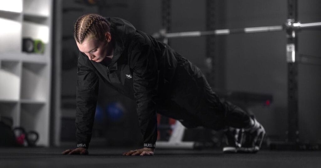 sauna suit female wearing on gym floor
